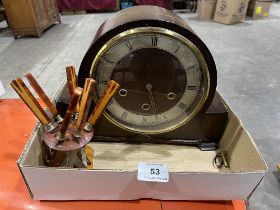 A 1940s mantle clock and a set of cake knives on a stand