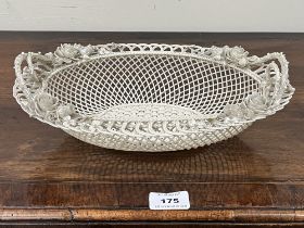 A Belleek oval basket, first period (1865-1899); the three-strand basket of twin handled form,