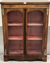 A Victorian walnut and inlaid pier cabinet with gilt metal mounts, enclosed by a pair of arched