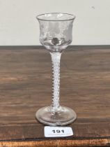 An 18th Century cordial glass, the ogee bowl engraved with vine fruits, on opaque airtwist stem