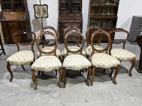 A set of six and a pair of Victorian walnut salon chairs on French cabriole forelegs. (8)