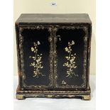 A 19th Century Oriental lacquer table cabinet on stand, decorated with gilt flowers, the pair of