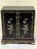 A 19th Century Oriental lacquer table cabinet on stand, decorated with gilt flowers, the pair of