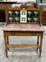 A late Victorian satin pine washstand, the marble top with splashback inset with tube-lined Art-