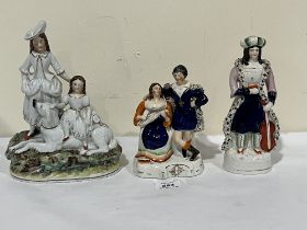 Two 19th Century Staffordshire groups and a Staffordshire figure of a musician in eastern dress. 9½"