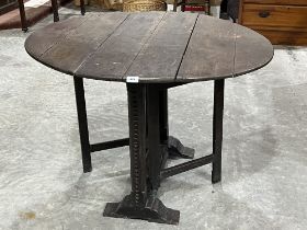 An antique joined oak gateleg table on chip carved square end supports and primitive gatelegs.