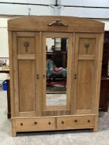 A Continental pine wardrobe with a pair of base drawers. 59"w x 78"h