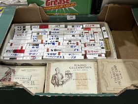 A box of cigarette cards in albums and packets.