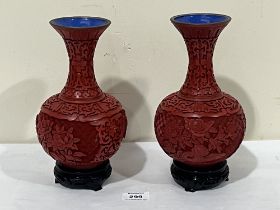 A pair of Oriental carved cinnabar baluster vases. 8" high.