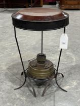 A 19th Century heater with brass paraffin burner and wrought iron supports. 27" high.