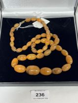 A necklace of graduated amber beads. 60g. 31½" long.