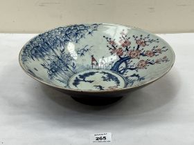 A Chinese bowl, decorated with trees and prunus. 12" diam. Broken and re-stuck.