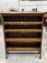 An early 20th Century oak open bookcase with three leather fringed adjustable shelves. 42" wide.