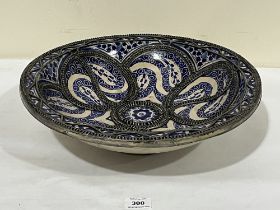 A Moroccan blue and white decorated and wire applied 'fez' bowl. 15½" diam.