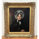 ENGLISH SCHOOL. 19TH CENTURY A portrait of a lady wearing a lace bonnet. Oil on lined canvas 30" x