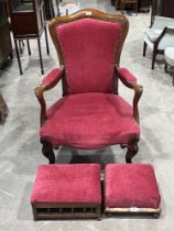 A Victorian rosewood and upholstered armchair and two Victorian footstools