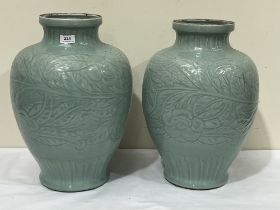 A pair of Oriental inverted baluster vases carved with foliage. 18½" high.