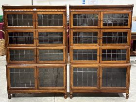 A pair of 1920s Minty mahogany bookcases, each enclosed by four pairs of leaded glazed doors. 35"w x