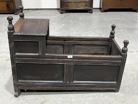 A late 17th Century joined oak panelled cradle. 37" long. Later repairs, faults.