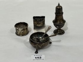 A silver salt; two silver salt spoons; a silver pepperette; a silver napkin ring and a silver