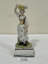 An early 19th Century Staffordshire pearlware figure of a street seller. 6" high