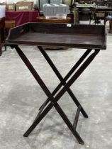 A 19th Century butler's tray on folding stand. 30" wide.