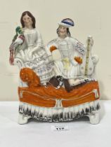 A 19th Century Staffordshire flat back group of a gentleman with lute and a lady with bird. 10"