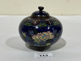 A Japanese cloisonne enamel jar and cover, decorated wih continuous band of flowers and flying