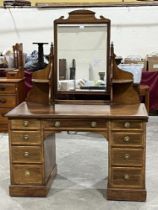 A late Victorian mahogany lined inlaid and banded kneehole dressing table by Heals. 48" wide.
