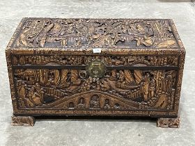An Oriental carved camphorwood blanket chest. 35" wide