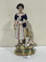 A 19th Century Staffordshire pearlware group of girl with two lambs. 8¼" high