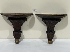 A pair of carved oak and parcel gilt wall brackets. 11" high.