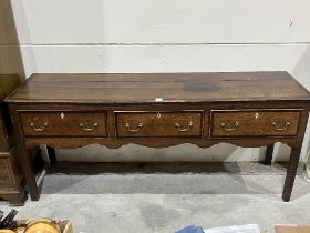 A George III oak and mahogany crossbanded low dresser with three drawers on square legs. 73" wide.