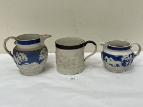 Two Victorian blue and white sprigged jugs and a large salt glazed mug moulded with a continuous