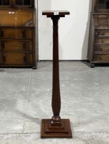 A mahogany reeded torchere on stepped base. 47½" high.