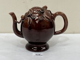 A 19th Century treacle glazed Cadogan teapot. 6½" high.