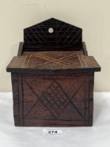 A 19th Century carved oak salt box. 7" wide.