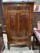 A 19th Century mahogany bow-fronted standing corner cupboard. 62" high.