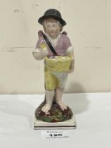 A 19th Century Staffordshire pearlware figure of a winged boy with basket. 7" high