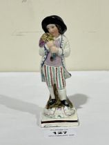 An early 19th Century Staffordshire pearlware figure of a boy with duck over his shoulder. 5½" high