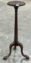 A Victorian mahogany torchere on fluted column and carved tripod support. 37" high