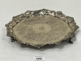 A George III silver salver with shell cast rim and chased decoration of scrolled foliage. London