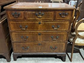 A George II walnut and line inlaid chest, the moulded top over three short and three long