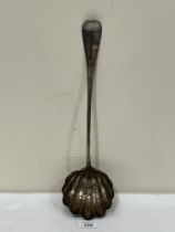 A white metal soup ladle with shell moulded bowl. 19th Century. 15" long