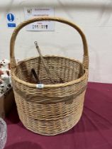 A wicker log basket, 20" diam and two carpet beaters.