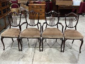 A set of four early 20th Century mahogany shield back salon chairs on cabriole legs. One chair