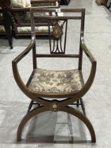 An Edward VII mahogany and inlaid 'X' framed armchair.