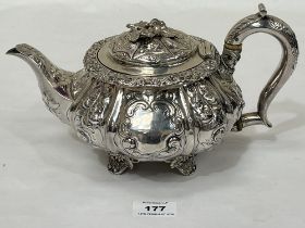 A George IV silver teapot, chased with foliage, the lid with applied cast leafage. London 1824. 10½"