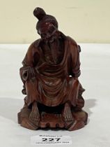 An Oriental carved boxwood figure of a seated sage. 5" high.