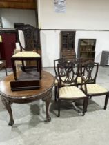 An early 20th Century mahogany oval dining table, extending to 70" long with one extra leaf;